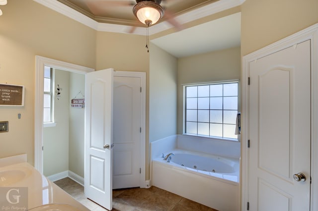 bathroom featuring ornamental molding, vanity, tile patterned flooring, baseboards, and a tub with jets