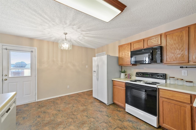 kitchen featuring an inviting chandelier, white appliances, decorative light fixtures, and a textured ceiling