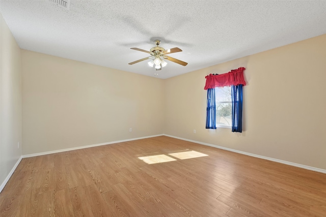 empty room featuring ceiling fan, a textured ceiling, and light wood-type flooring