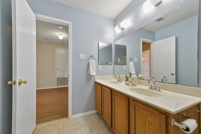 bathroom featuring vanity and a textured ceiling