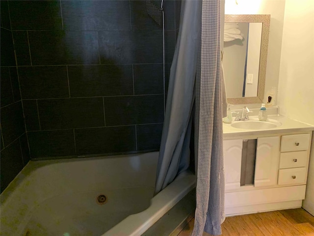 bathroom featuring vanity, wood-type flooring, and shower / bath combo