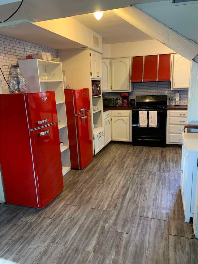 kitchen with white cabinetry, refrigerator, dark hardwood / wood-style floors, black range with electric stovetop, and decorative backsplash