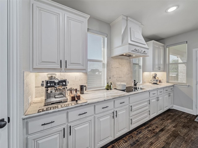 kitchen with white cabinets, custom exhaust hood, dark wood-type flooring, backsplash, and black electric cooktop