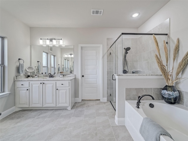 bathroom with plus walk in shower, tile patterned floors, and vanity