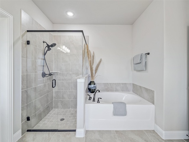 bathroom with shower with separate bathtub and tile patterned floors