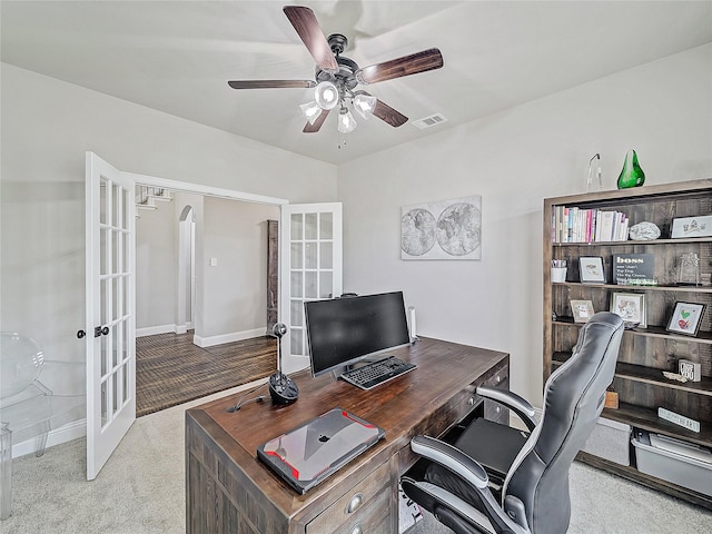 office space featuring ceiling fan, light colored carpet, and french doors