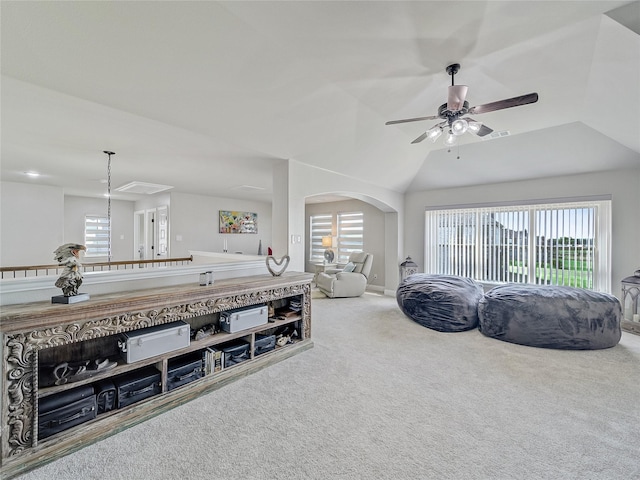 living room with vaulted ceiling, ceiling fan, and carpet floors