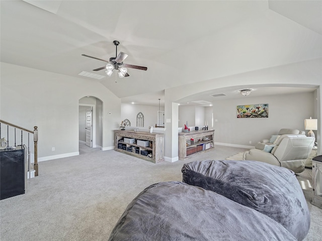 living room with ceiling fan, lofted ceiling, and light colored carpet