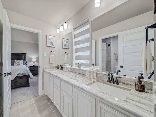 bathroom with walk in shower, tile patterned floors, and vanity