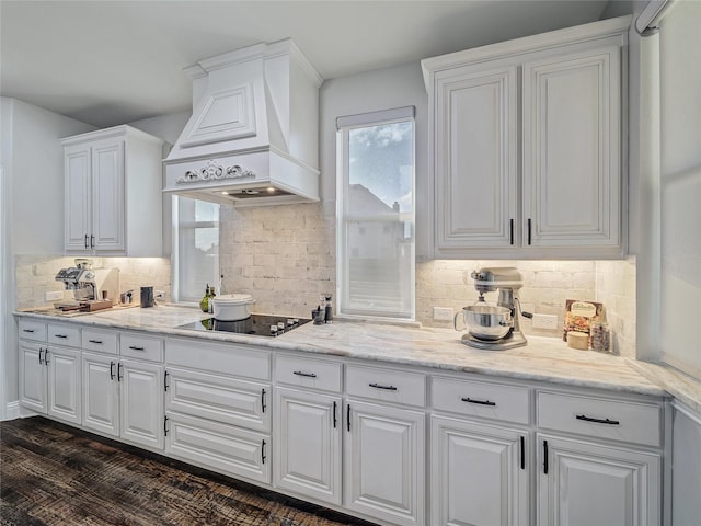 kitchen featuring white cabinets, black electric stovetop, dark hardwood / wood-style flooring, and custom range hood