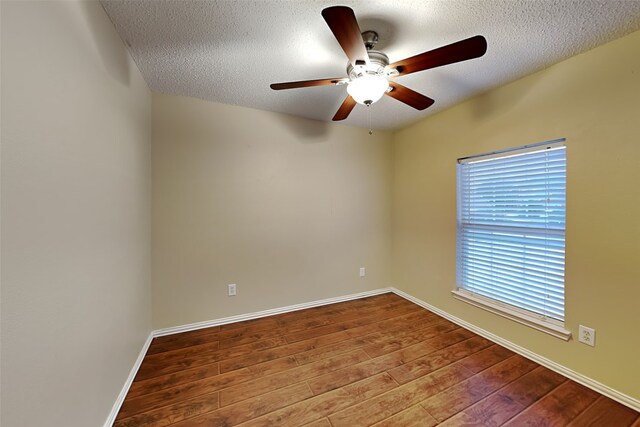 spare room with ceiling fan, a textured ceiling, and hardwood / wood-style floors