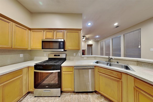 kitchen with ceiling fan, backsplash, sink, appliances with stainless steel finishes, and light tile patterned floors