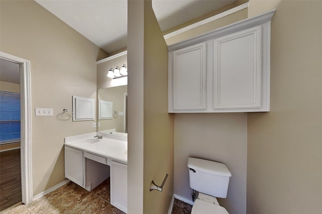 bathroom with toilet and vanity