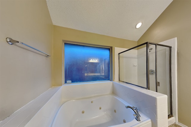 bathroom with a textured ceiling, independent shower and bath, and lofted ceiling