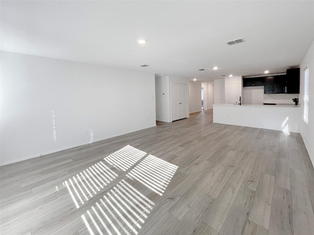 unfurnished living room featuring light hardwood / wood-style flooring