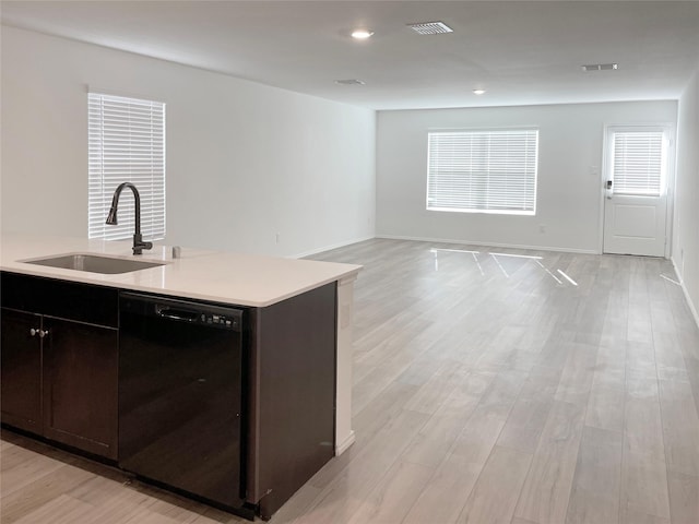 kitchen with sink, dark brown cabinetry, dishwasher, and light hardwood / wood-style flooring