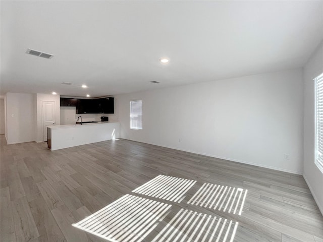 unfurnished living room featuring light hardwood / wood-style floors and plenty of natural light