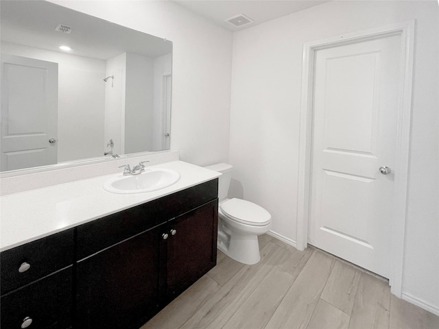 bathroom featuring toilet and vanity