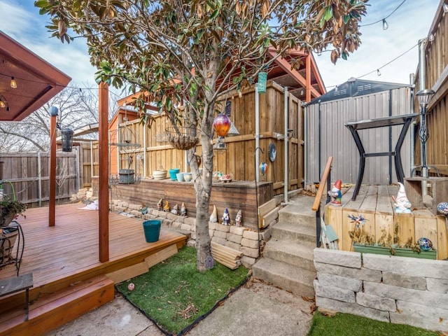 wooden deck featuring a storage unit