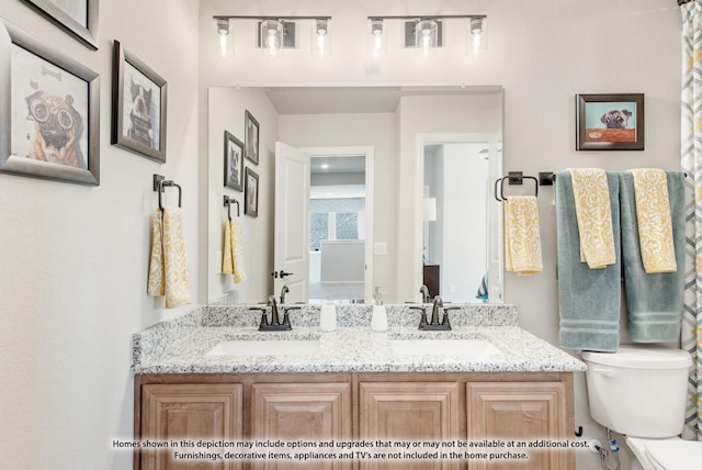 bathroom featuring toilet and vanity