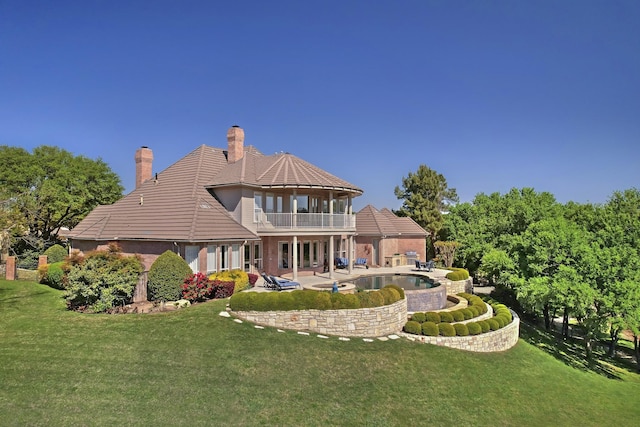 6601 Oak Hill Ct, Fort Worth, TX 76132 - back of property with a balcony, a yard, a patio area, and a chimney