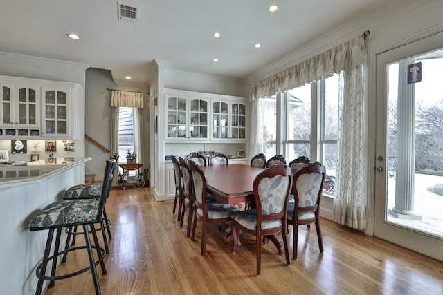 dining room featuring crown molding and light wood-type flooring