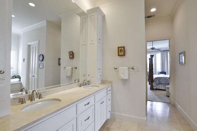 bathroom with crown molding, a wealth of natural light, vanity, and tile patterned floors