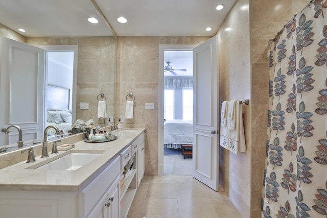 bathroom featuring a shower with shower curtain, vanity, tile patterned flooring, and tile walls