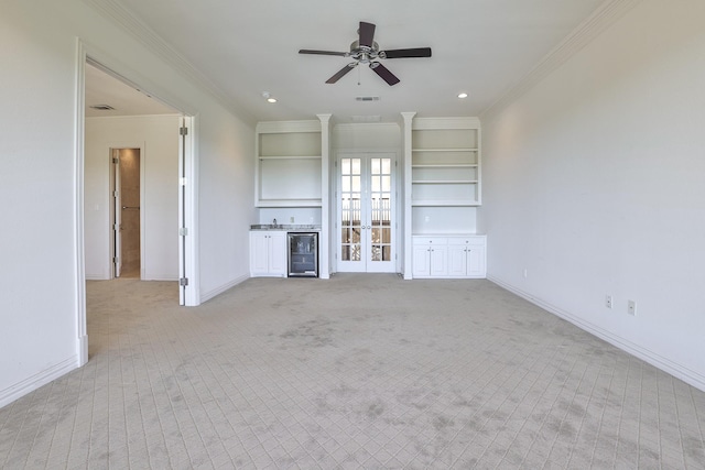6601 Oak Hill Ct, Fort Worth, TX 76132 - unfurnished living room featuring beverage cooler, light carpet, ceiling fan, crown molding, and baseboards