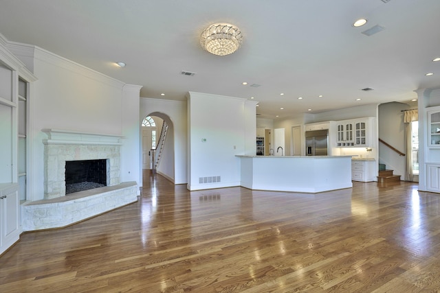 6601 Oak Hill Ct, Fort Worth, TX 76132 - unfurnished living room featuring stairway, a fireplace, ornamental molding, dark wood-style flooring, and recessed lighting