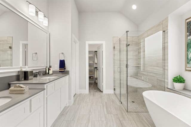 bathroom with shower with separate bathtub, vanity, and high vaulted ceiling