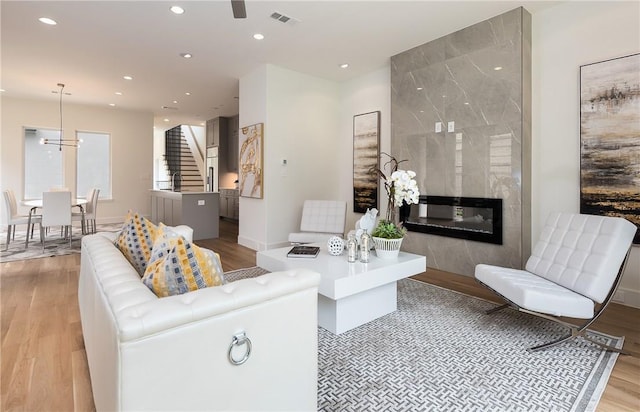 living room with light wood-type flooring and a premium fireplace