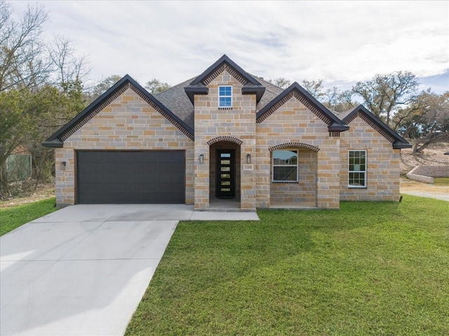 view of front of home with a garage and a front lawn