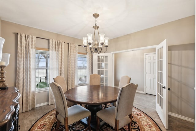 dining space featuring an inviting chandelier and hardwood / wood-style floors