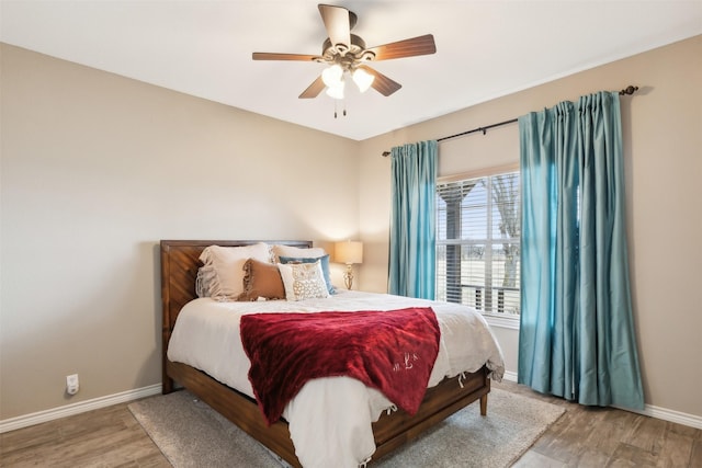 bedroom with ceiling fan and hardwood / wood-style floors