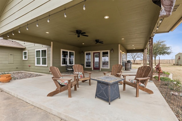 view of patio / terrace with ceiling fan and an outdoor fire pit