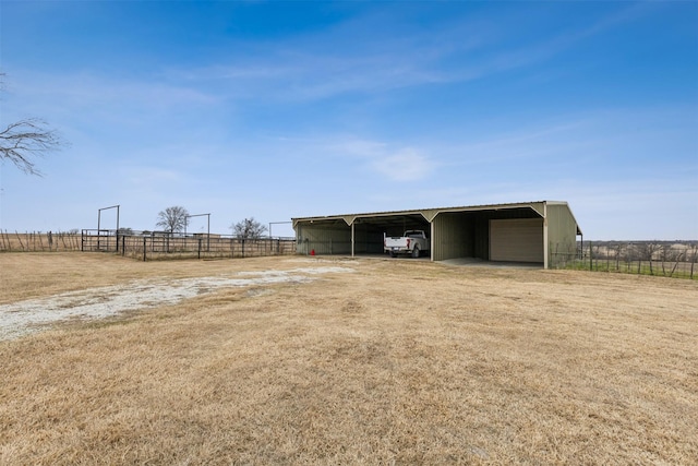 view of yard featuring an outbuilding and a rural view