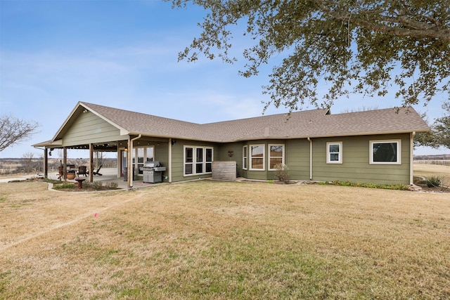 back of house featuring a patio area and a yard