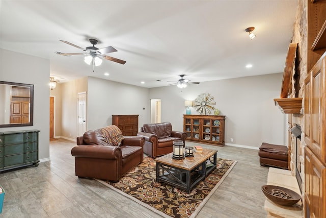 living room with ceiling fan and light wood-type flooring