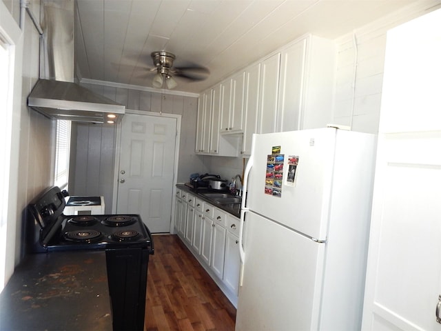 kitchen with wall chimney range hood, white cabinets, black range with electric stovetop, and white fridge