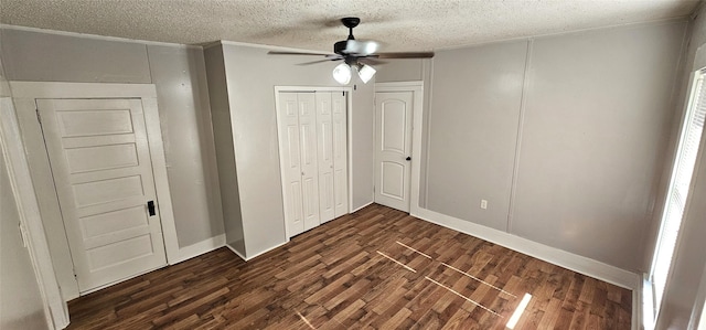 unfurnished bedroom featuring ceiling fan, dark hardwood / wood-style flooring, and a textured ceiling