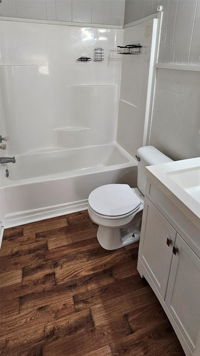 full bathroom featuring hardwood / wood-style floors, toilet, vanity, and bathing tub / shower combination