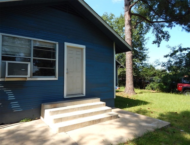 doorway to property featuring a patio area and cooling unit