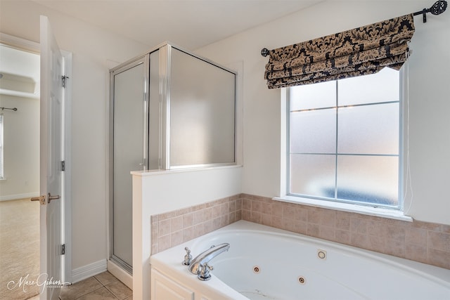 bathroom with tile patterned flooring and independent shower and bath