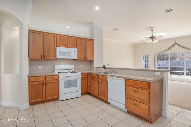 kitchen featuring white appliances, sink, backsplash, ornamental molding, and kitchen peninsula