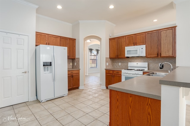 kitchen with light tile patterned flooring, sink, ornamental molding, and white appliances