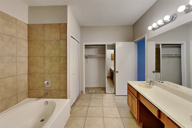 bathroom featuring a textured ceiling, tile patterned flooring, and vanity