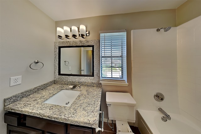 full bathroom featuring toilet, vanity, and tiled shower / bath