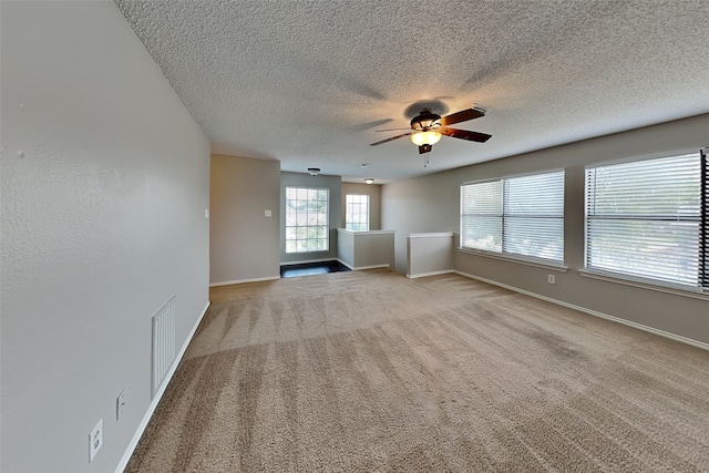 unfurnished living room with light carpet and ceiling fan