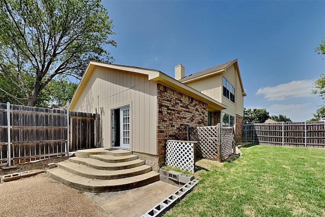 rear view of property featuring a yard